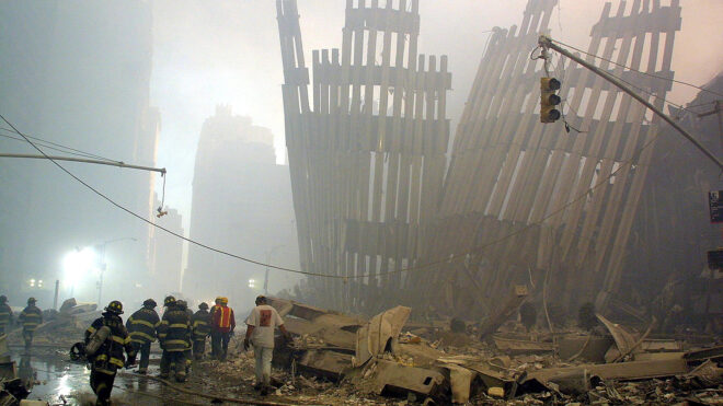 Firefighters make their way through the rubble of the World Trade Center on Sept. 11 2001, in New York after two hijacked planes flew into the landmark skyscrapers. (Doug Kanter/AFP via Getty Images/TNS)