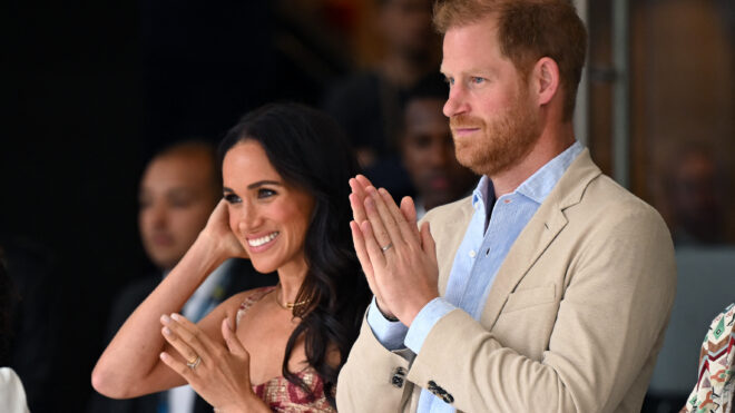 Britain's Prince Harry (C), Duke of Sussex, and his wife Meghan Markle react while attending a show during a visit to the National Centre for the Arts in Bogota on August 15, 2024. Prince Harry and his wife, American actress Meghan Markle, arrived in Colombia at the invitation of Colombia's vice-President Francia Marquez, with whom they will attend various meetings with women and young people to reject discrimination and cyberbullying. (Photo by RAUL ARBOLEDA / AFP) (Photo by RAUL ARBOLEDA/AFP via Getty Images)