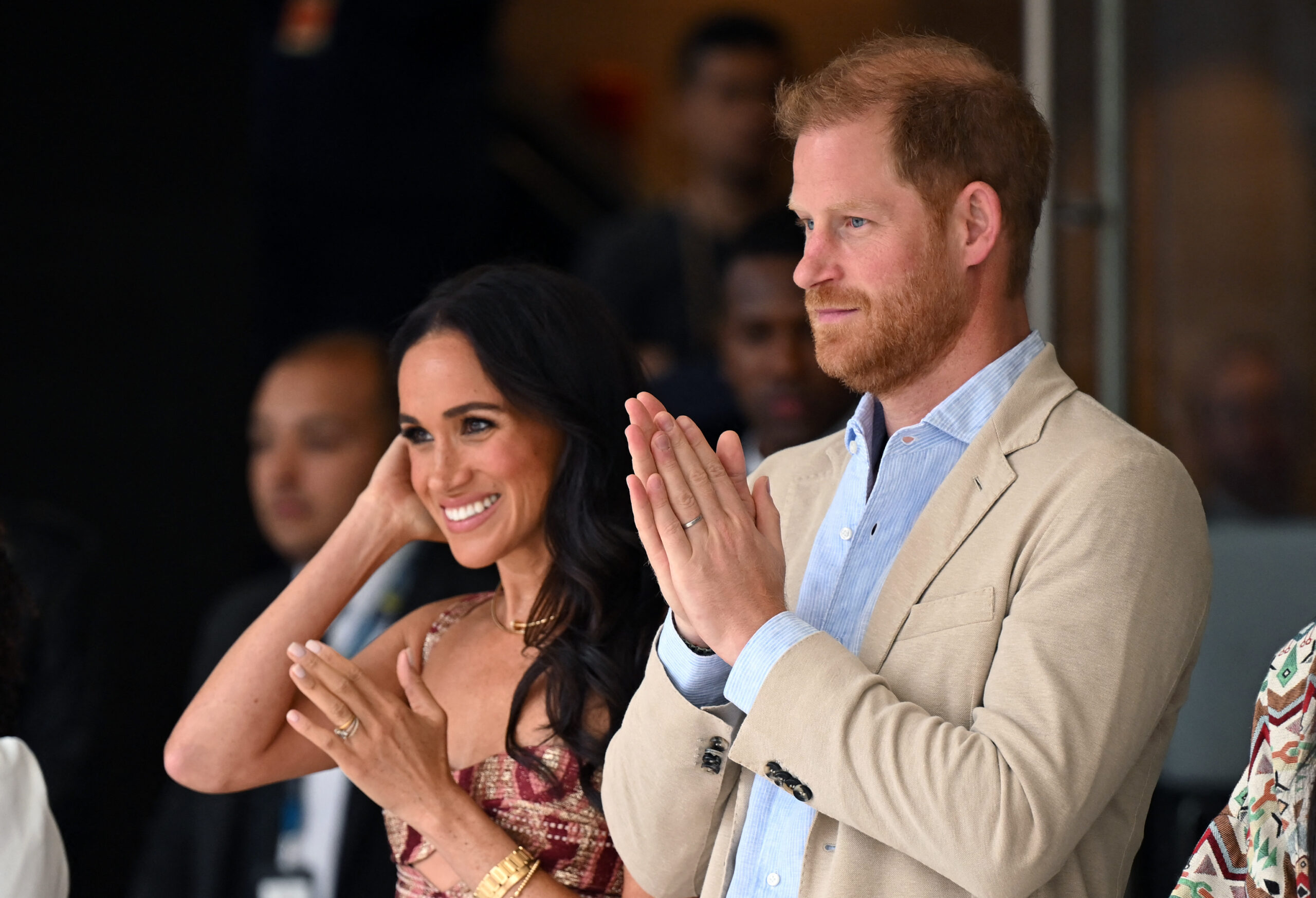 Britain's Prince Harry (C), Duke of Sussex, and his wife Meghan Markle react while attending a show during a visit to the National Centre for the Arts in Bogota on August 15, 2024. Prince Harry and his wife, American actress Meghan Markle, arrived in Colombia at the invitation of Colombia's vice-President Francia Marquez, with whom they will attend various meetings with women and young people to reject discrimination and cyberbullying. (Photo by RAUL ARBOLEDA / AFP) (Photo by RAUL ARBOLEDA/AFP via Getty Images)