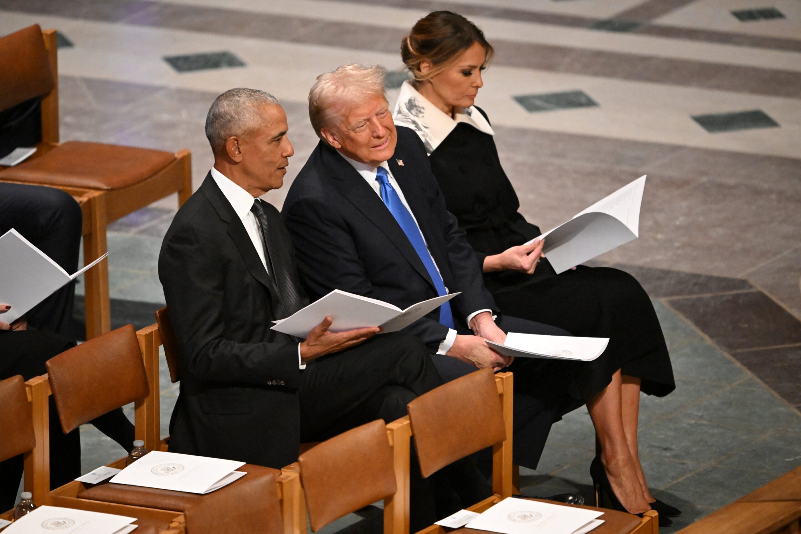TOPSHOT - Former US President Barack Obama speaks with President-elect Donald Trump as they attend the State Funeral Service for former US President Jimmy Carter at the Washington National Cathedral in Washington, DC, on January 9, 2025. (Photo by Mandel NGAN / AFP) (Photo by MANDEL NGAN/AFP via Getty Images)