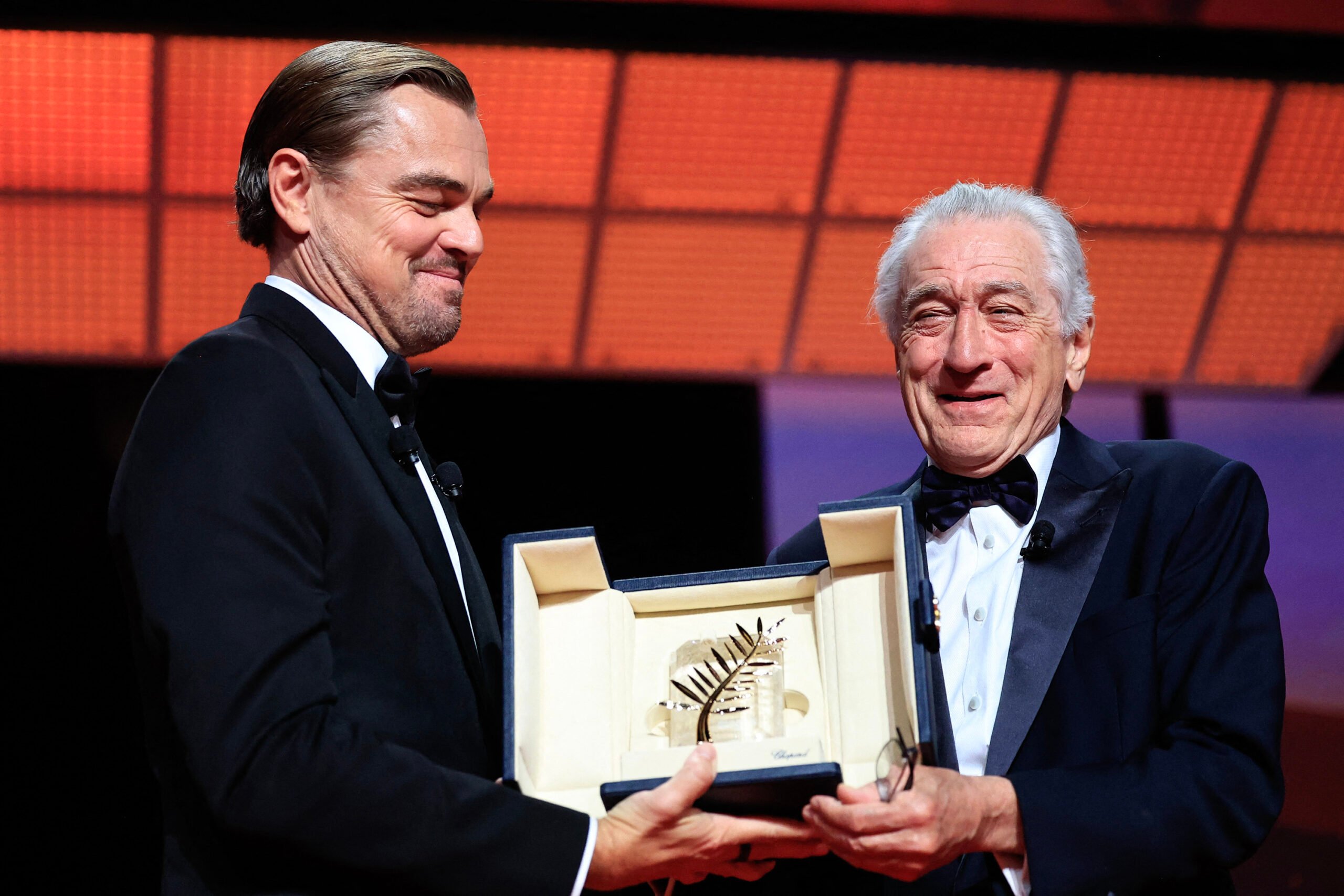 Robert De Niro, right, receives an honorary Palme d'Or from Leonardo Dicaprio during the opening ceremony of the 78th edition of the Cannes Film Festival in Cannes, France, on May 13, 2025. (Valery Hache/AFP/Getty Images/TNS)