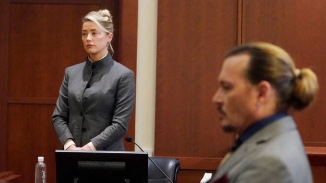 Actors Amber Heard (left) and Johnny Depp watch as the jury leaves the courtroom at the end of the day at the Fairfax County Circuit Courthouse in Fairfax, Virginia, May 16, 2022. Depp sued his ex-wife, Heard, for libel after she wrote an op-ed piece in The Washington Post in 2018 referring to herself as a "public figure representing domestic abuse." (Steve Helber/Pool/AFP via Getty Images/TNS)