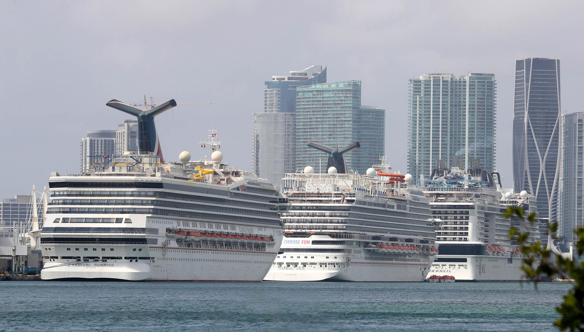 Carnival Cruise Line's ships Sunrise, left, and Vista, center, along with the MSC Meraviglia, are docked at the Port of Miami on Feb. 18, 2021. Sunrise, formerly named Triumph, experienced an emergency in 2013 when the ship, full of travelers, lost power for four days while returning to Texas. (Susan Stocker/South Florida Sun Sentinel/TNS)