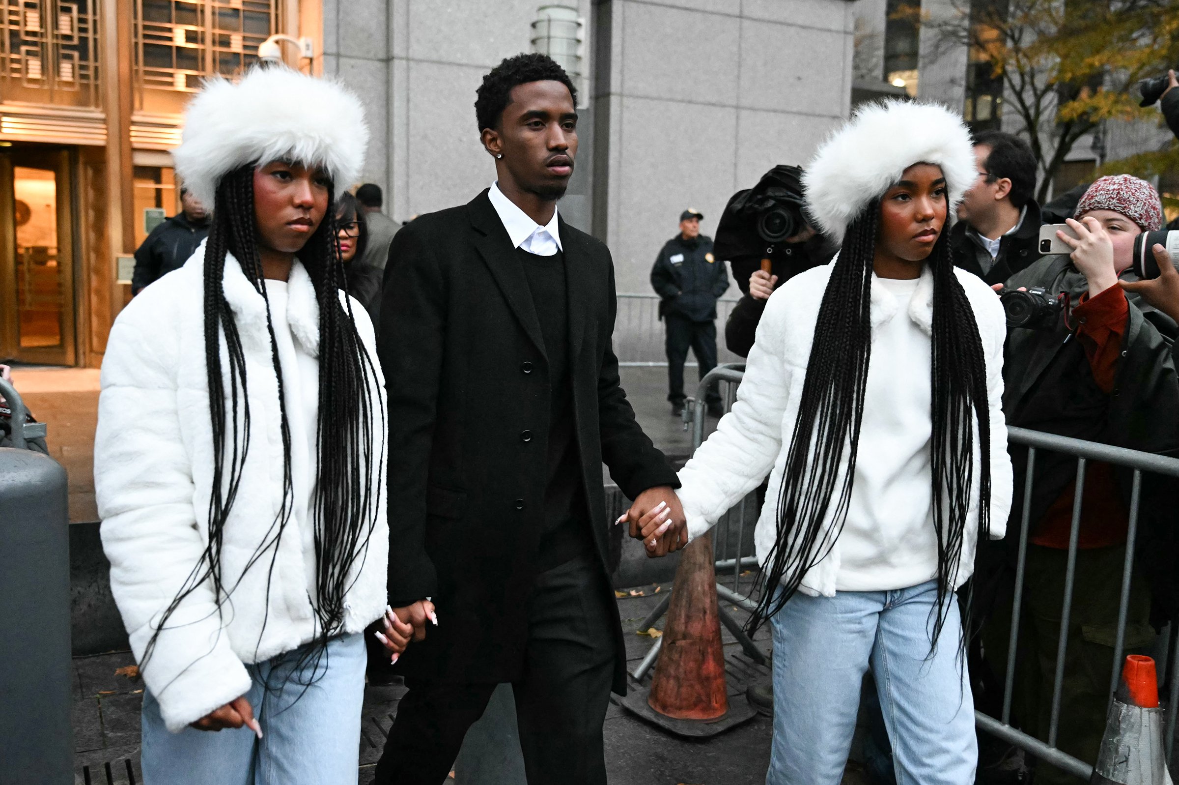 Sean "Diddy" Combs' children King Combs, center, and twins Jessie and D'Lila Combs hold hands as they leave the federal court after his bail hearing on Nov. 22, 2024, in New York City. (Timothy A. Clary/AFP via Getty Images/TNS)
