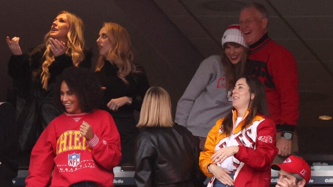 Brittany Mahomes looks on while Taylor Swift hugs her father, Scott Swift, with Alana Haim, right, while the Kansas City Chiefs and the New England Patriots play at Gillette Stadium on Dec. 17, 2023, in Foxborough, Massachusetts. (Maddie Meyer/Getty Images/TNS)