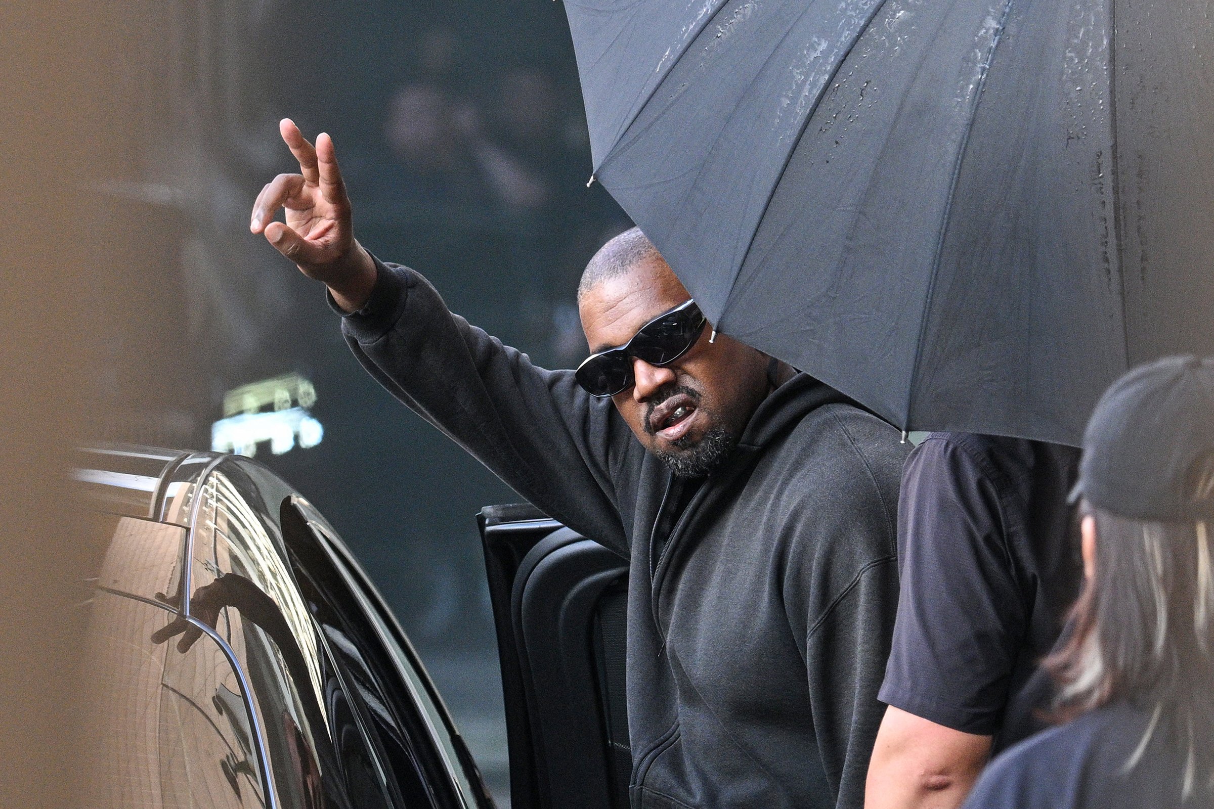 Kanye West gestures upon arriving at Shanghai Pudong International Airport on July 11, 2025. (Hector Retamal/AFP via Getty Images/TNS)