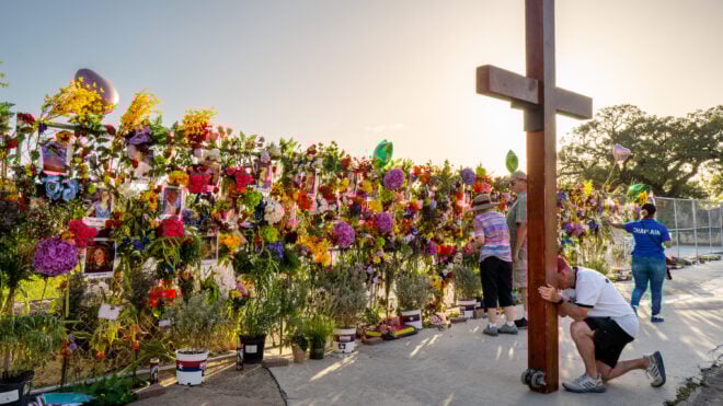 Community residents grieve and pay their respects at a memorial on July 10, 2025, in Kerrville, Texas. Last Friday, heavy rainfall caused severe flash flooding throughout the hill country and various cities along the Guadalupe River. (Brandon Bell/Getty Images/TNS)