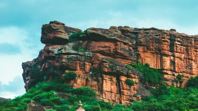 A striking close-up of a cliff in Badami, Karnataka, with natural rock formations.