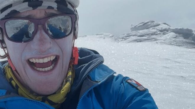 Balin Miller climbing snowy mountain.