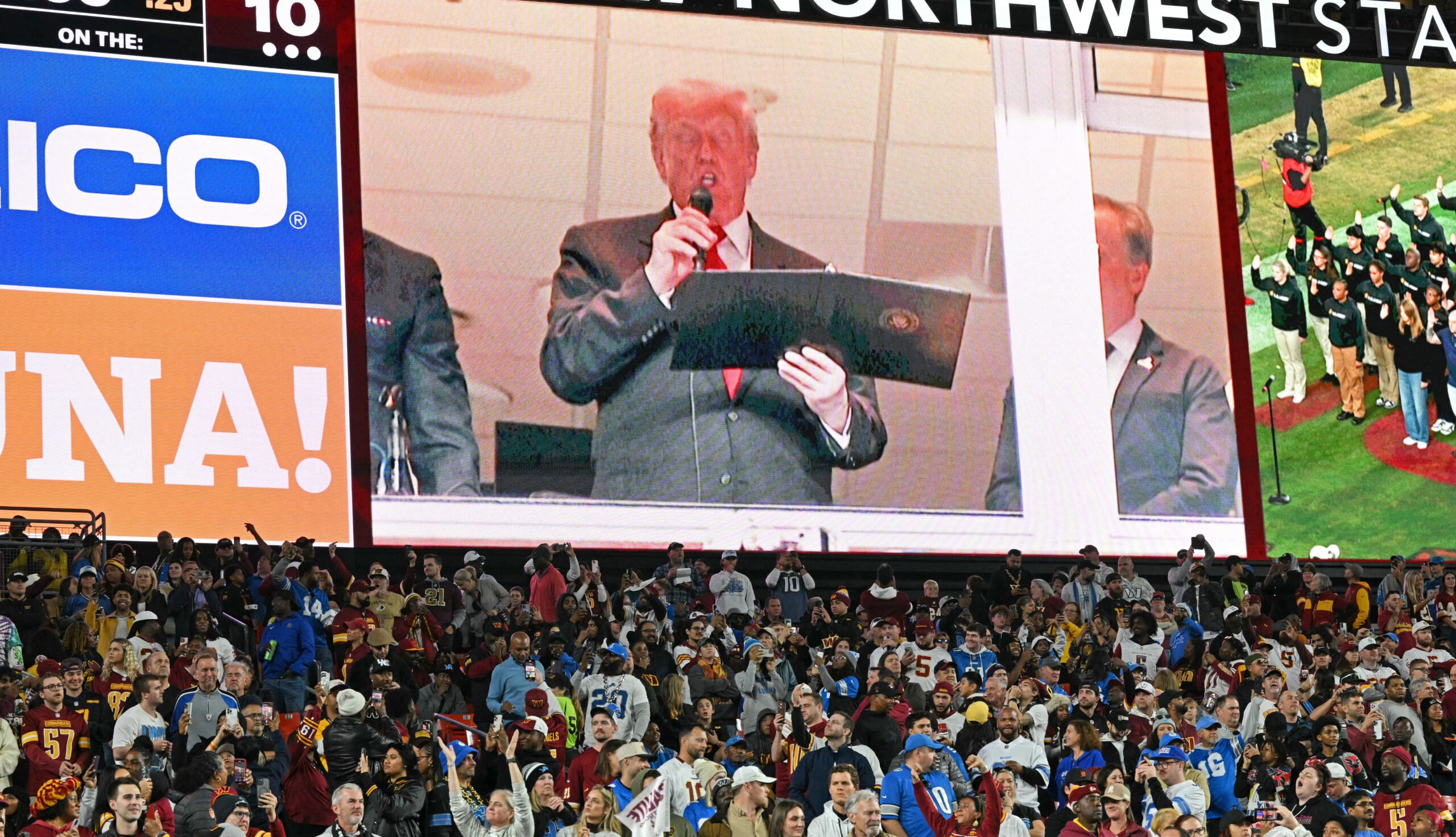 US President Donald Trump at a football game on the screen