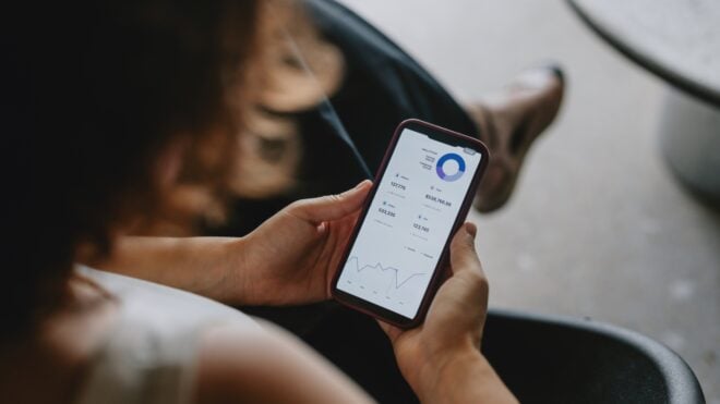 woman looking at her banking on her phone