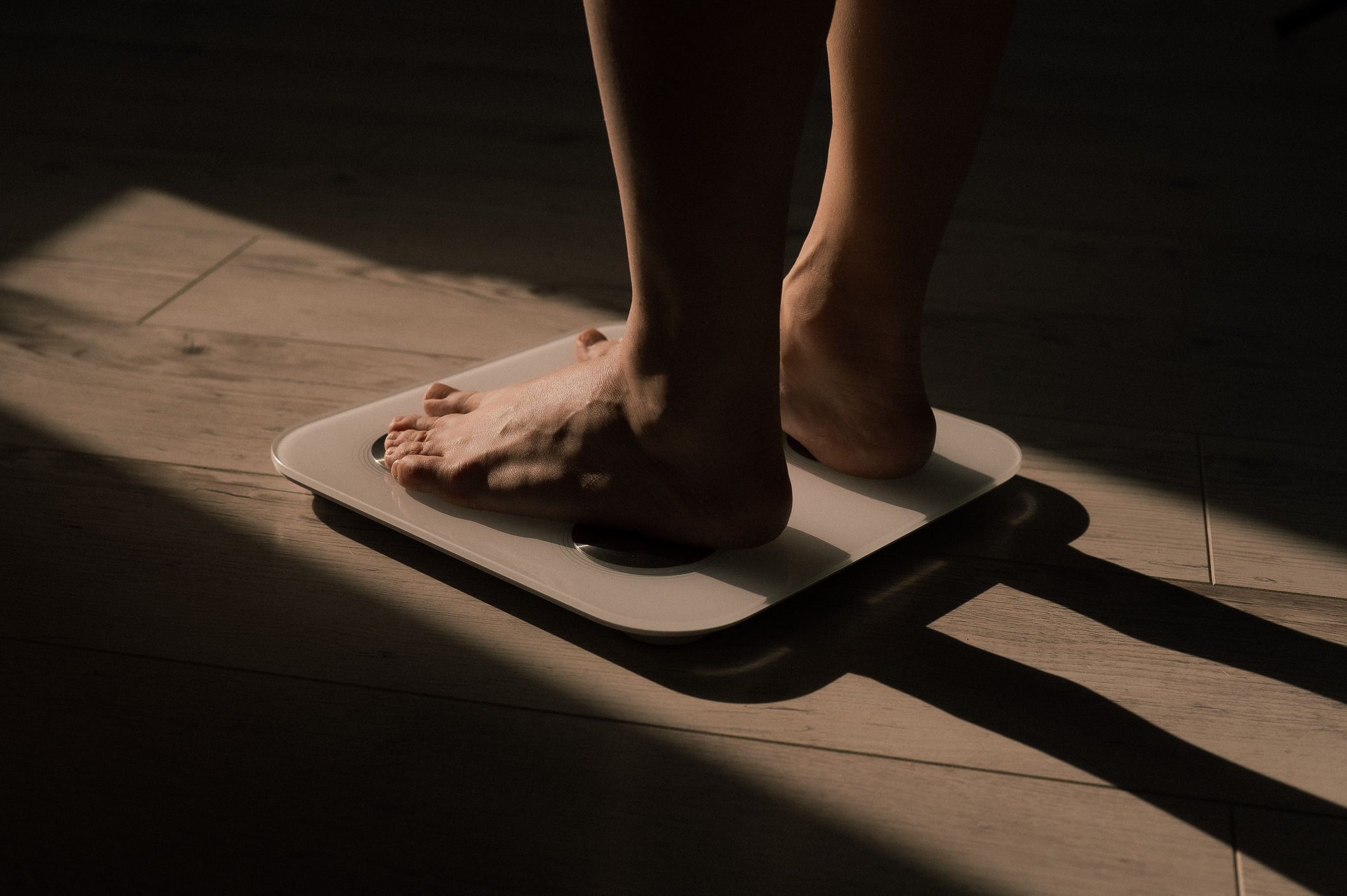 Close-up of female legs on electronic scales