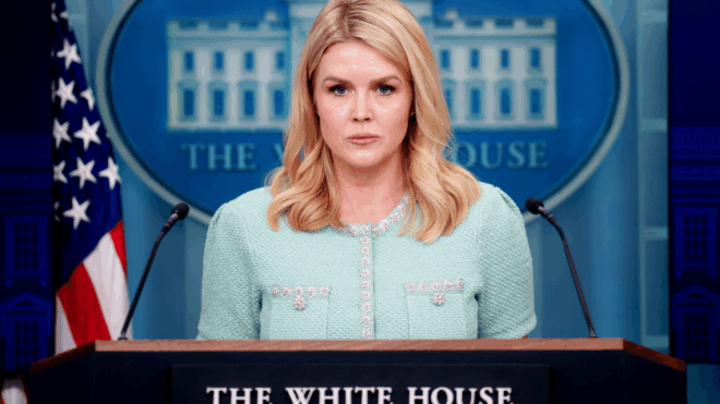 Karoline Leavitt standing behind White House podium