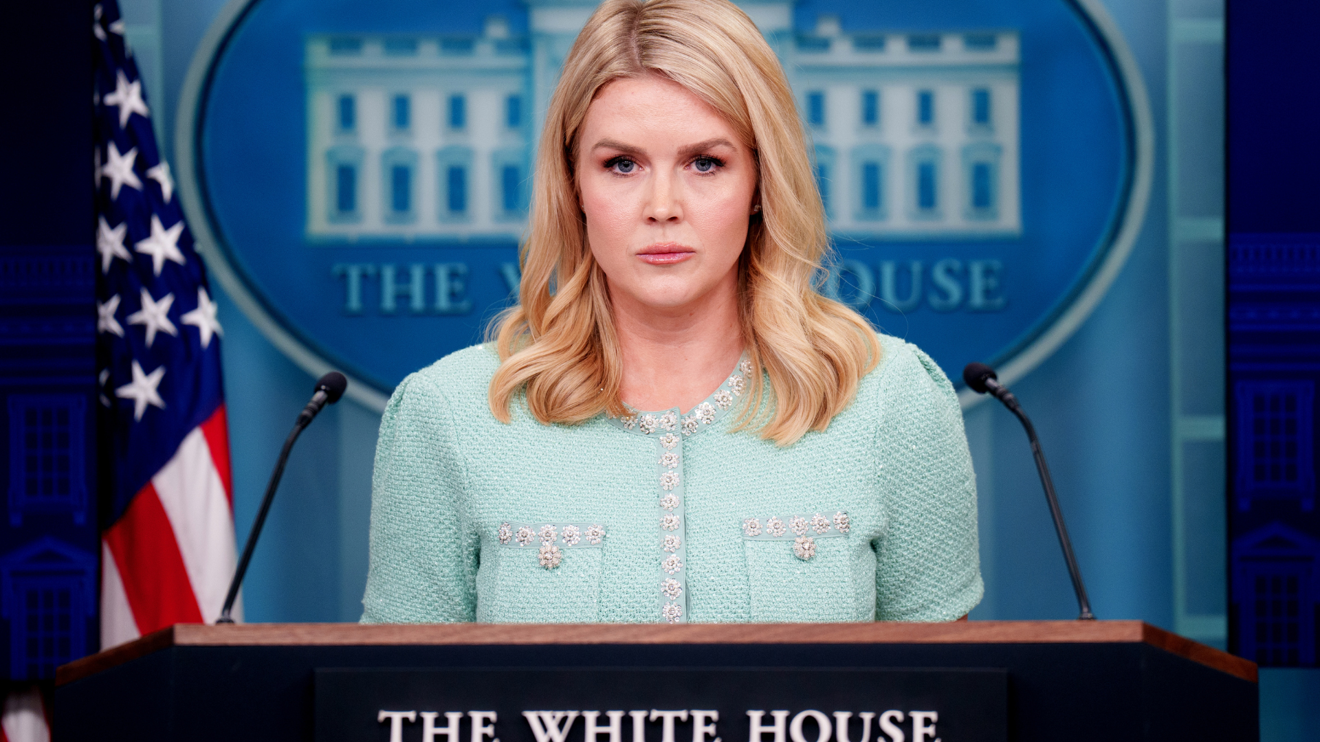 Karoline Leavitt standing behind White House podium