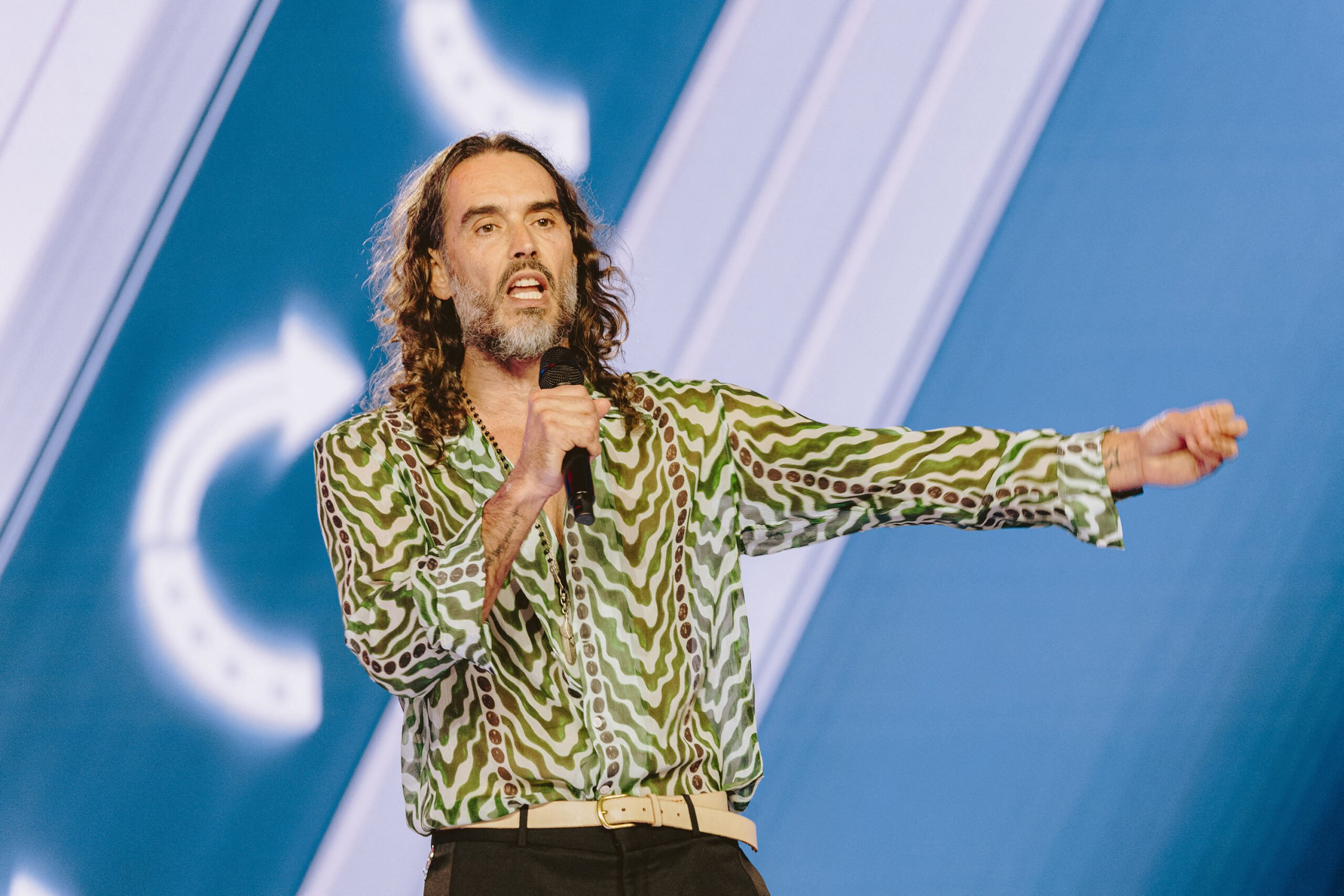 Russell Brand speaks during Turning Point's annual AmericaFest conference in Phoenix on Thursday, Dec. 18, 2025.