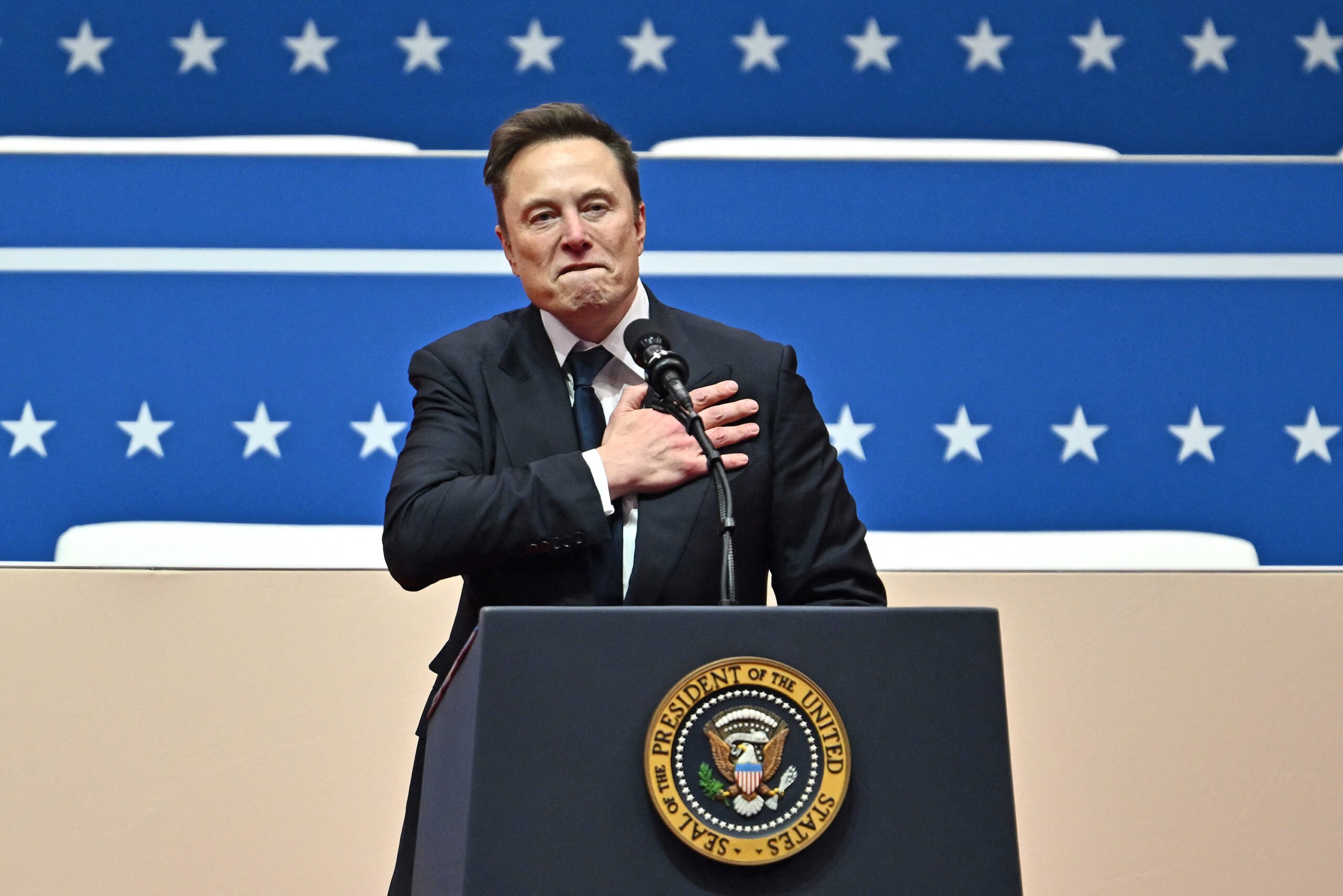Tesla and SpaceX CEO Elon Musk gestures as he speaks during the inaugural parade inside Capitol One Arena, in Washington, D.C., on Monday, Jan. 20, 2025.