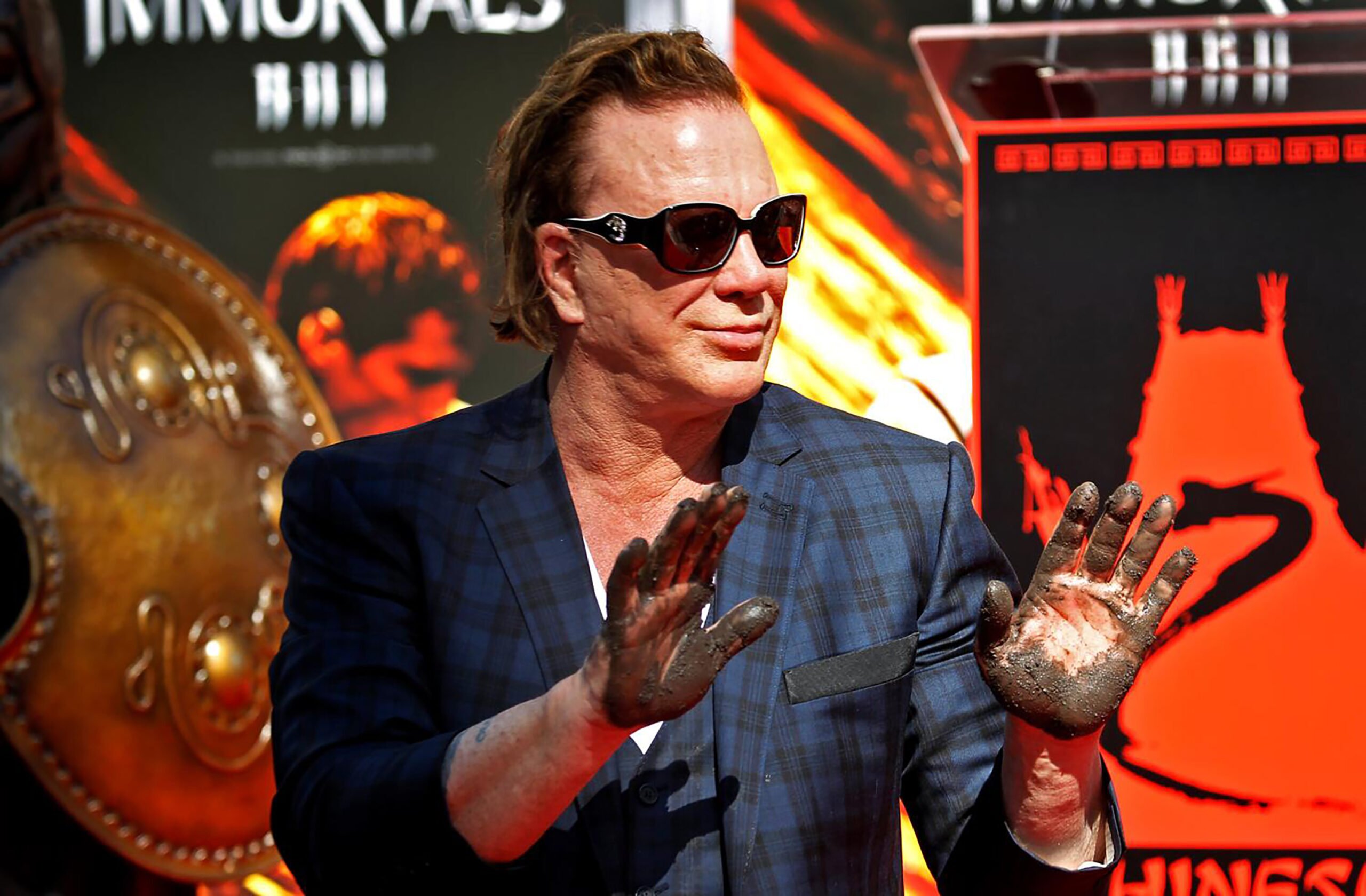 Oscar nominated actor Mickey Rourke shows his wet hands after he left his prints in wet cement in the famed forecourt at Grauman's Chinese Theatre in Hollywood