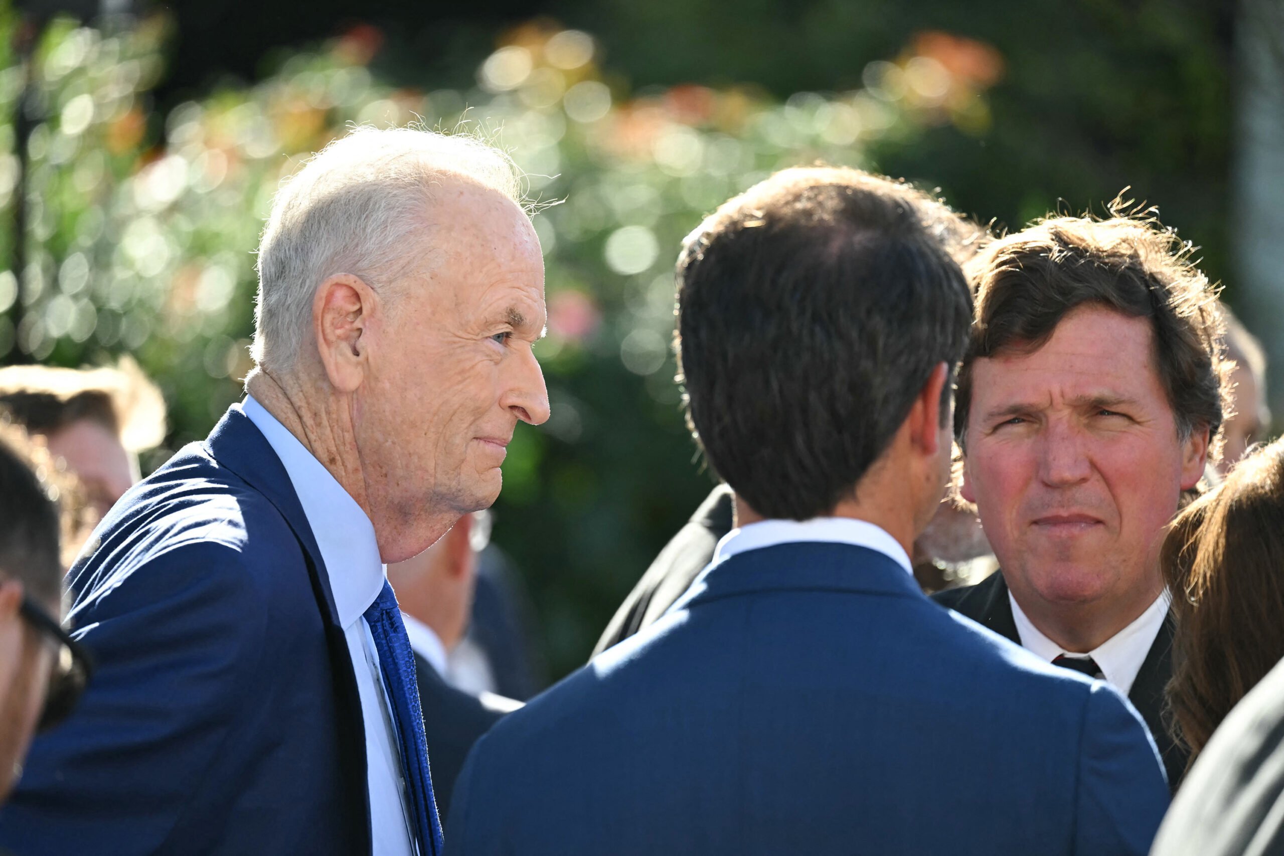Fox News talk show host Jesse Watters (center) and former Fox pundits Bill O'Reilly (left) and Tucker Carlson
