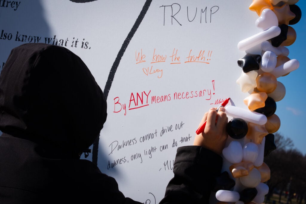 People signing installation of Trump's alleged birthday card to Epstein
