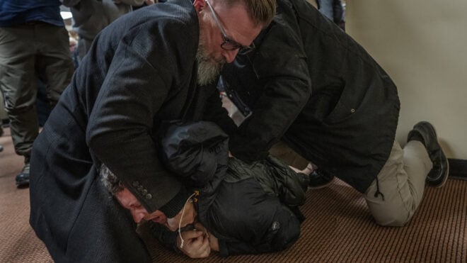 A man is tackled to the ground