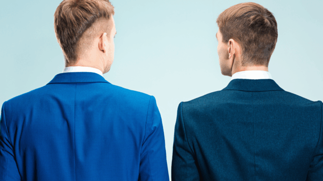 two men standing with their back to the camera