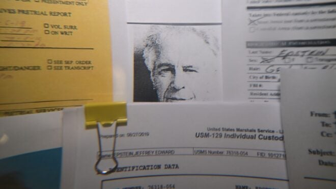 Released documents from the U.S. Justice Department files on Jeffrey Epstein displayed on a board.