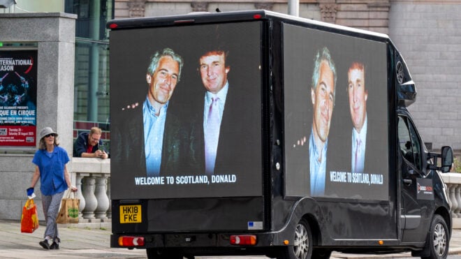 A photograph of President Donald Trump and convicted child sex offender Jeffery Epstein is displayed on the side of a van