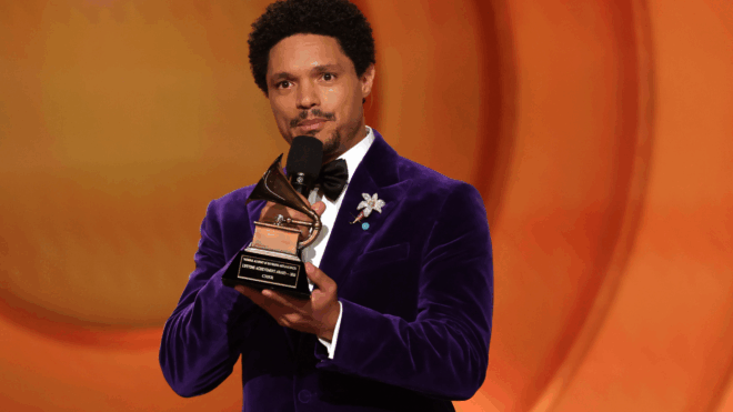 Honoree Cher accepts a Lifetime Achievement Award from host Trevor Noah onstage