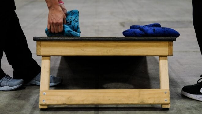 Cornhole is a popular lawn game where players toss bean bags from 27 feet away at a raised board with a hole, aiming to reach 21 points
