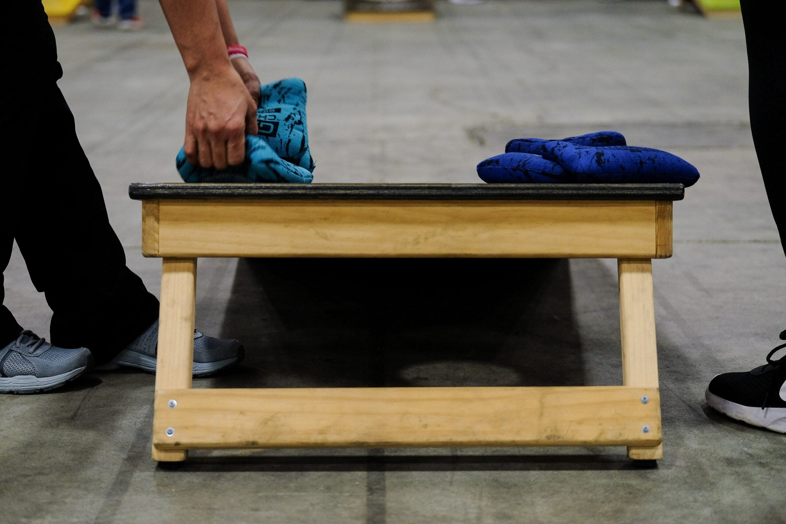 Cornhole is a popular lawn game where players toss bean bags from 27 feet away at a raised board with a hole, aiming to reach 21 points