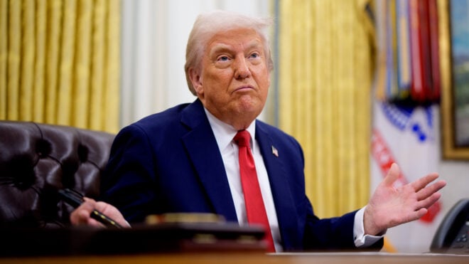 President Donald Trump gestures while speaking during an executive order signing event in the Oval Office of the White House