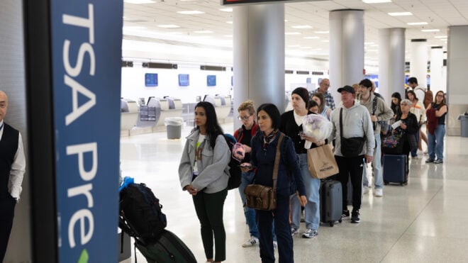 Travelers wait in a TSA Pre security line at Miami International Airport on Tuesday, March 17, 2026, in Miami.