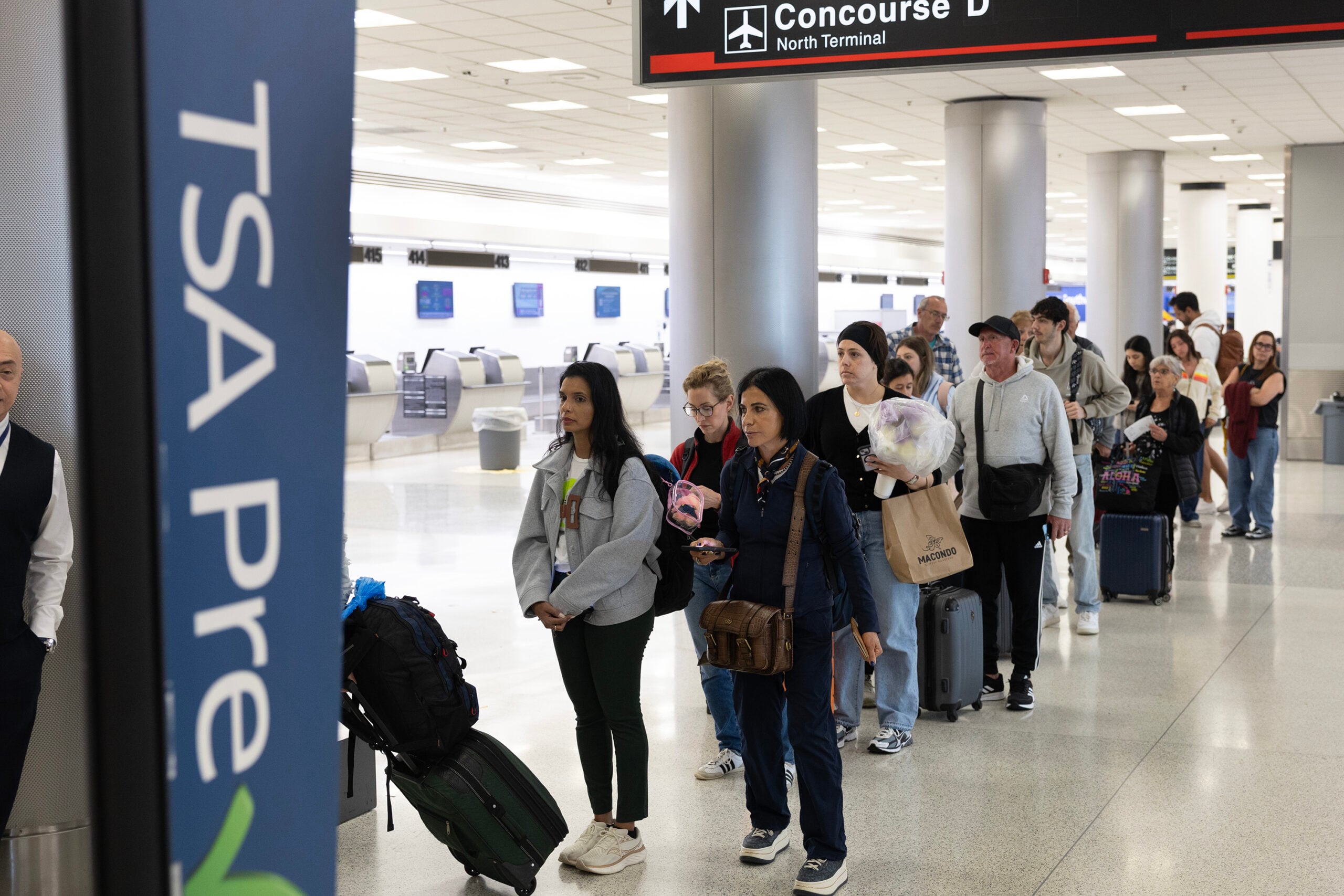 Travelers wait in a TSA Pre security line at Miami International Airport on Tuesday, March 17, 2026, in Miami.