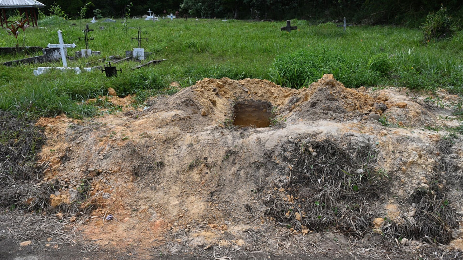 Curtis Chase / AFP/ Getty ImagesA view of an open grave at the cemetery of Cumuto, Trinidad and Tobago, taken on April 18, 2026. The remains of at least 50 infants and six adults were discovered on April 18, 2026, after they had apparently been discarded at a cemetery in Trinidad and Tobago, police said. (Photo by Curtis Chase / AFP)