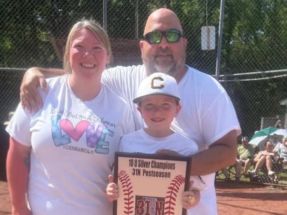 Stephen Morrow poses with his family during sons baseball achievement. P