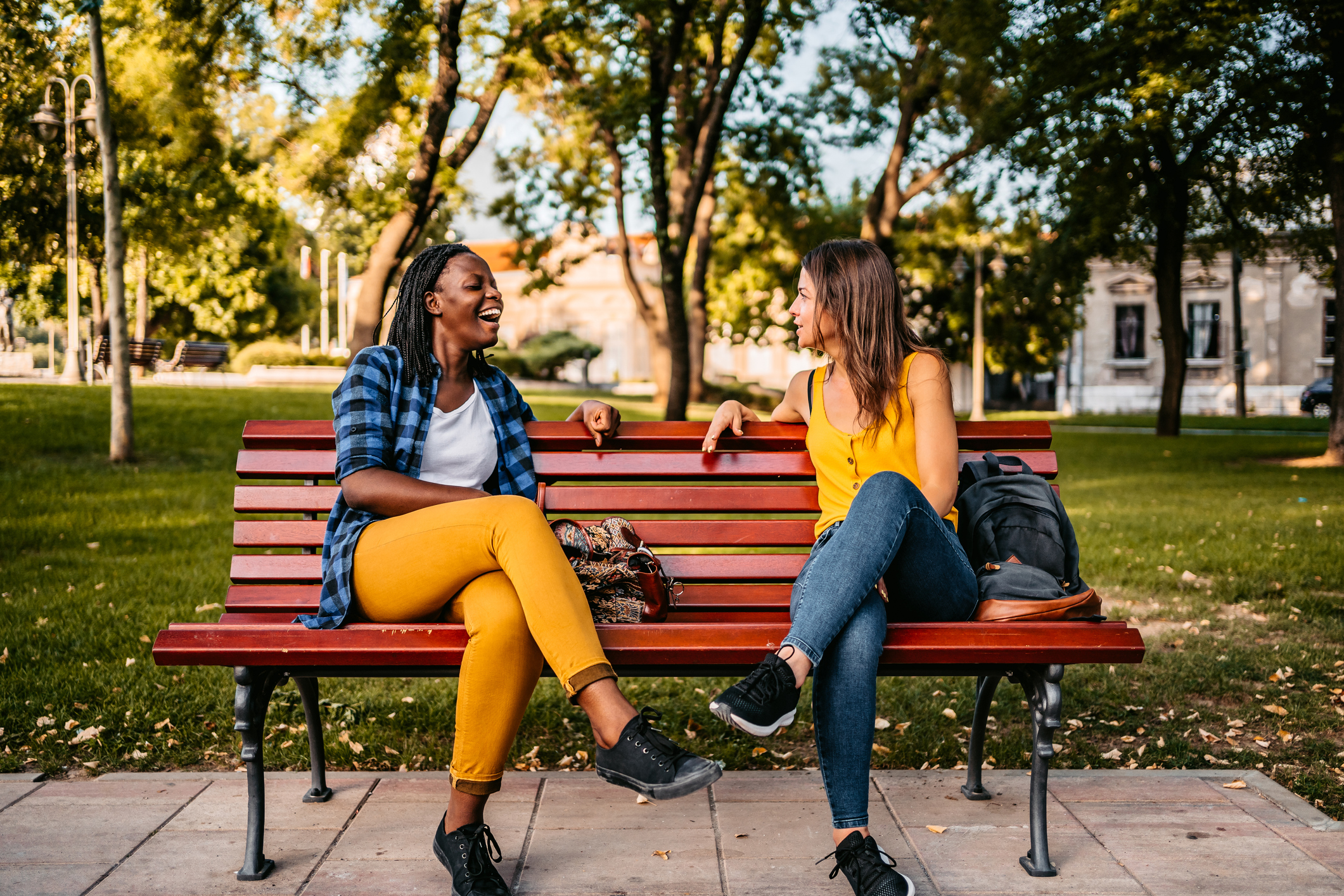 Friends talking on a bench