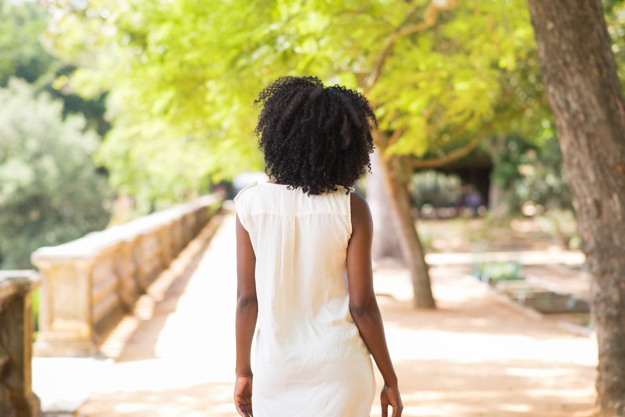 Rear view of young woman walking in park