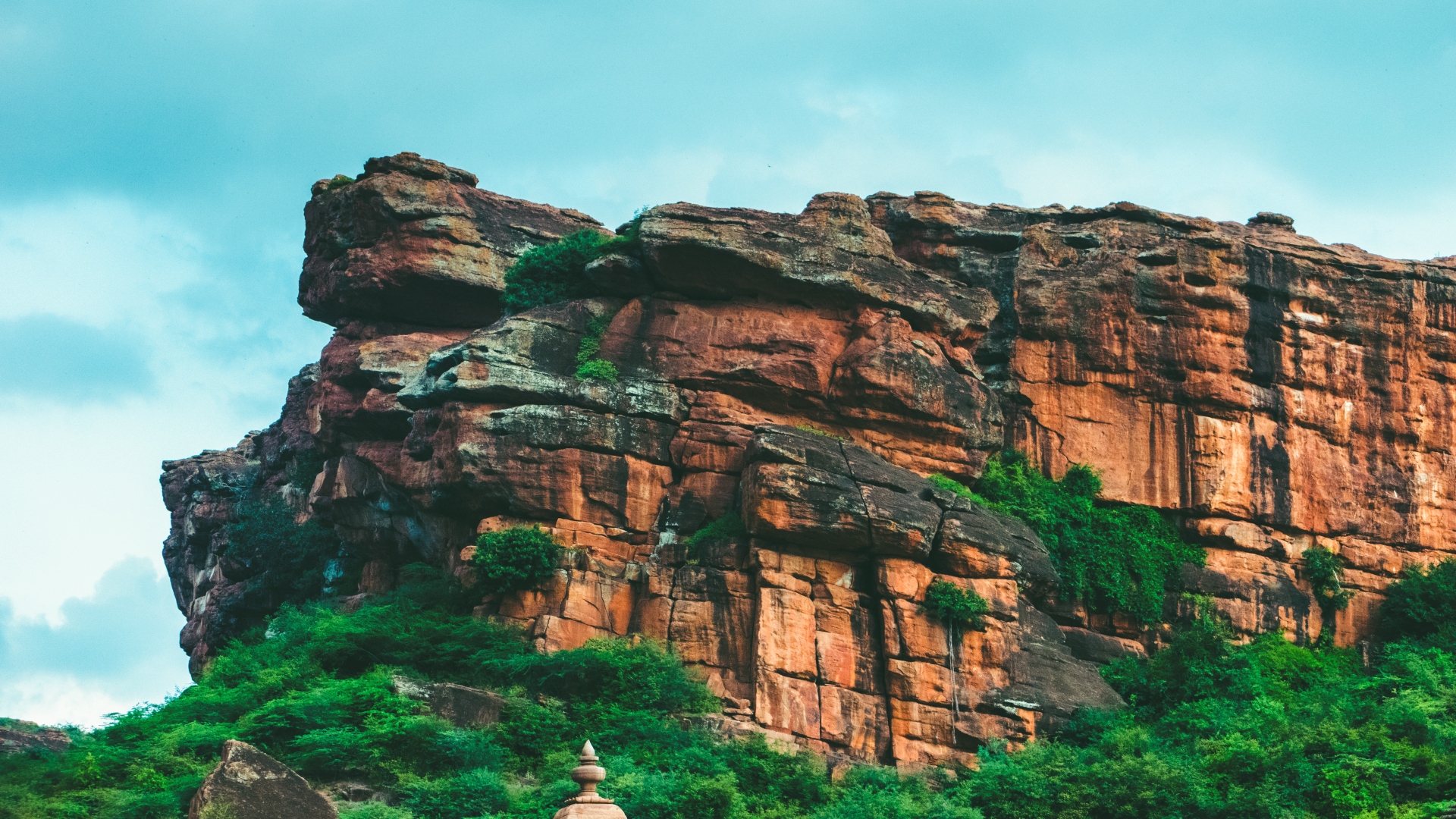 A striking close-up of a cliff in Badami, Karnataka, with natural rock formations.