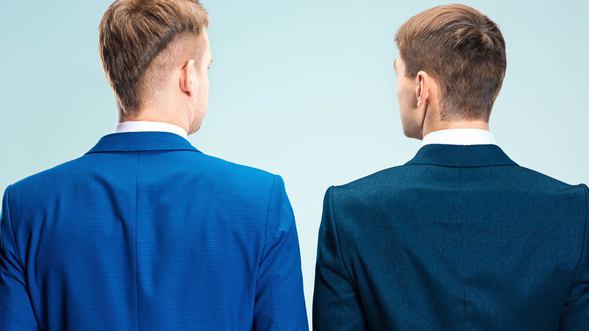 two men standing with their back to the camera