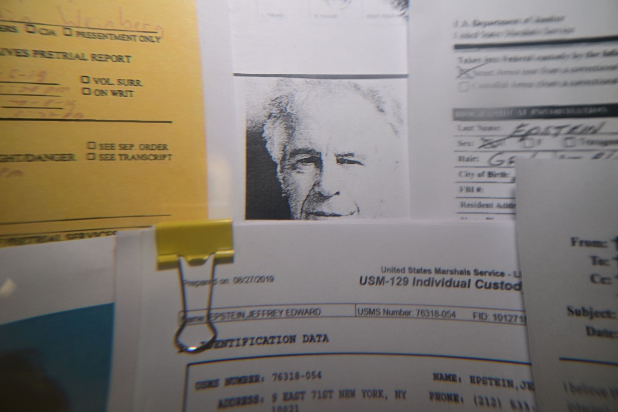 Released documents from the U.S. Justice Department files on Jeffrey Epstein displayed on a board.