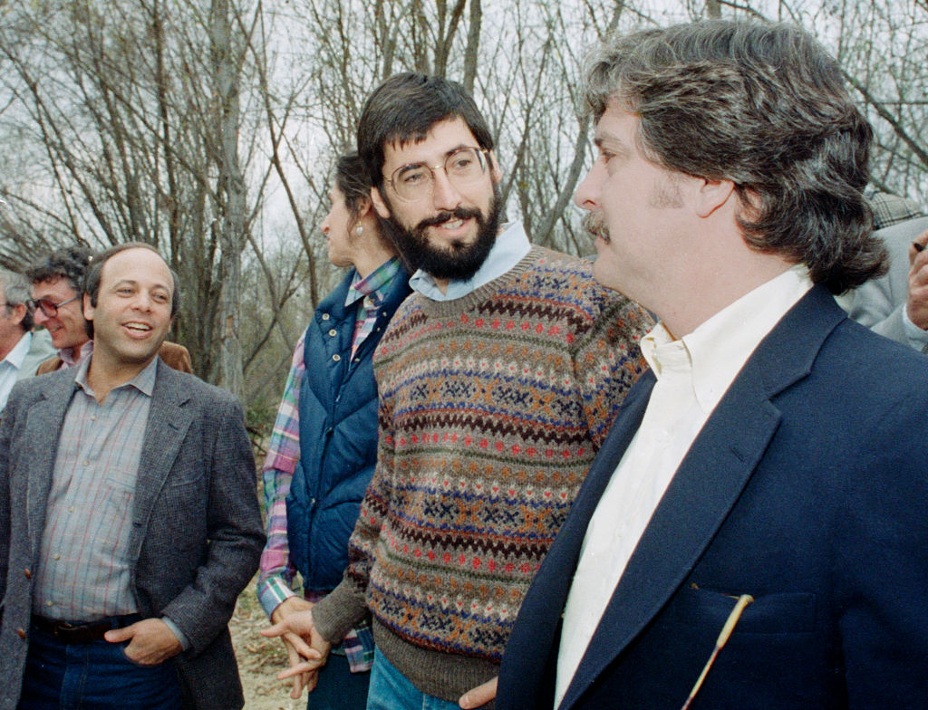 SAUGUS, CALIFORNIA - FEBRUARY 10 : Director John Landis, talks with representative after a Los Angeles County Fire Department helicopter flew a similar route above the Santa Clara River where a 1982 helicopter filming accident killed actor Vic Morrow and two children by a disabled helicopter, February 10, 1987 in Saugus, California. Saugus is located just North of Los Angeles.